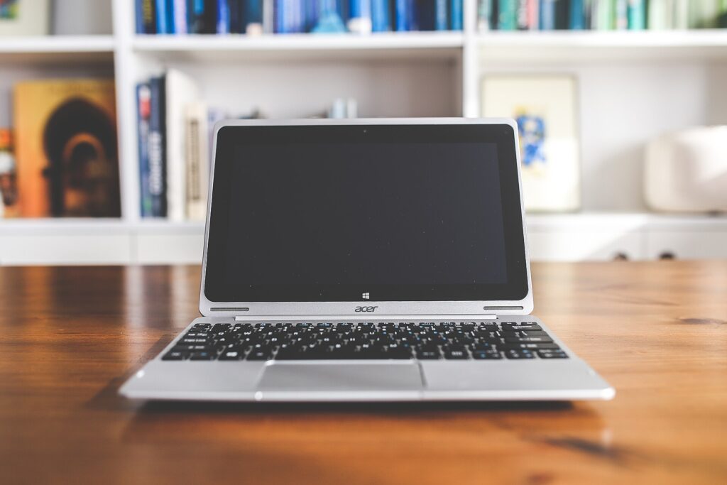 A shared table with laptop and notebook